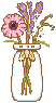 An image of some flowers in a tall vase.